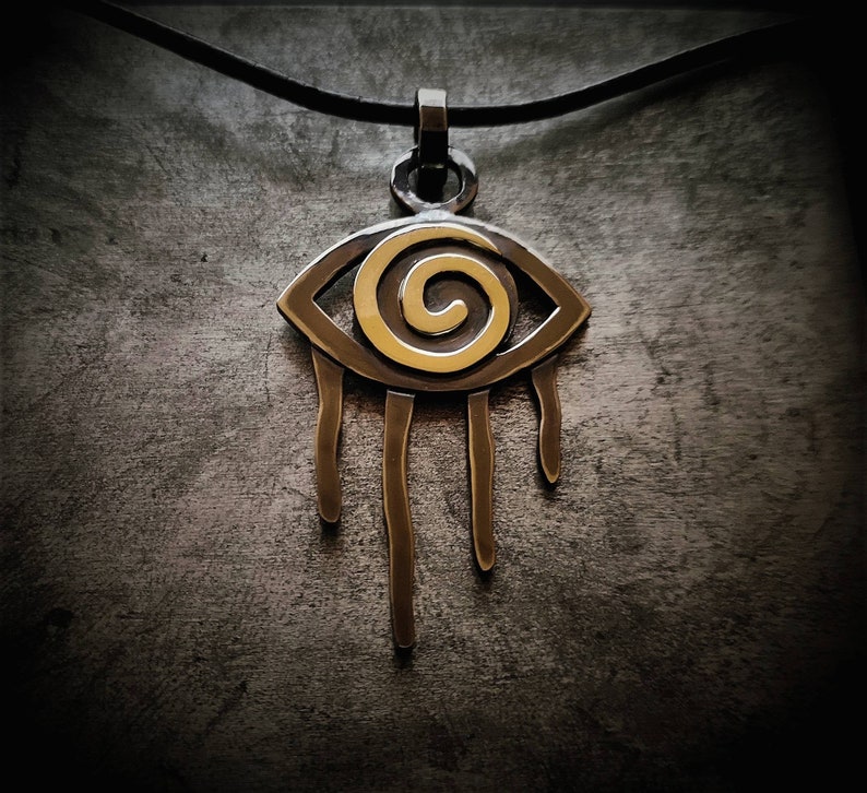 Oxidized silver pendant aztec style with gold eye