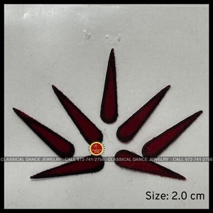May include: Six maroon-colored fabric embellishments in the shape of a pointed teardrop. The embellishments are arranged in a starburst pattern. The embellishments are 2.0 inches in diameter.  CLASSICAL DANCE JEWELRY: CALL 972-741-2756: CLASSICAL DANCE JEWELRY: CALL 972-741-2756