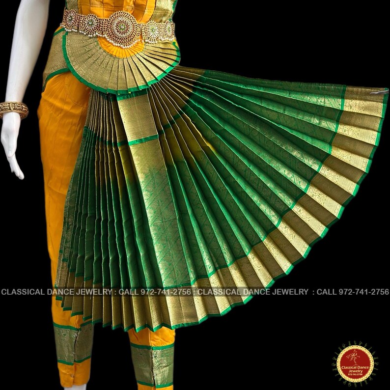 May include: A traditional Indian classical dance costume. The ensemble features a yellow top and pants, accented with green and gold trim. A fan-shaped skirt in green and gold is attached to a decorative belt. The image includes the text "CLASSICAL DANCE JEWELRY".