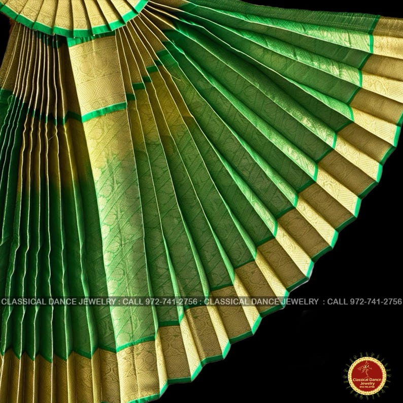 May include: Close-up of a fan-like, pleated fabric in shades of green and gold. The fabric has a textured appearance with intricate patterns. Green trim borders the gold sections. The text "CLASSICAL DANCE JEWELRY" and a phone number are visible.
