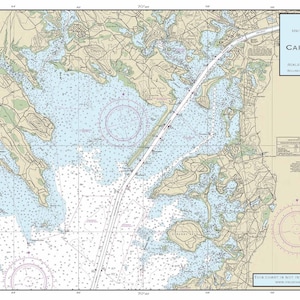 May include: A nautical chart of the Cape Cod Canal in Massachusetts. The chart shows the canal, surrounding waterways, and nearby land features. The chart is printed in black, blue, and brown on a white background. The chart is titled "Cape Cod Canal" and includes the text "United States - East Coast Massachusetts".