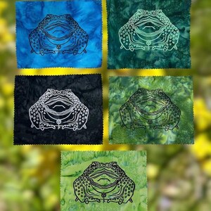 May include: Five rectangular fabric patches with pinked edges, each featuring a central line-art illustration of a toad wearing a key necklace. The backgrounds are marbled in blue, dark teal, black, forest green, and lime green color variations.