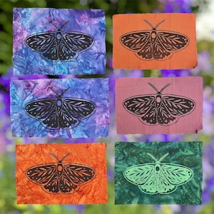 May include: Six rectangular fabric patches with pinked edges, each featuring a black moth illustration with celestial star and moon details. The backgrounds include marbled blue and purple, solid orange, solid pink, and mottled green patterns.