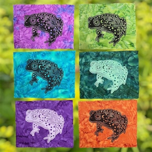 May include: Six rectangular fabric patches featuring a toad illustration with botanical and celestial patterns. The patches come in purple, lime green, teal, dark green, light purple, and orange, each with a distinct marbled batik texture.