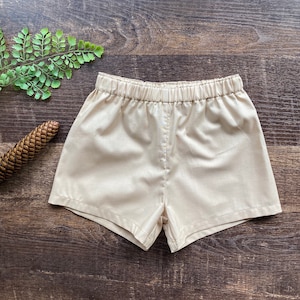 May include: A pair of beige shorts with an elastic waistband.