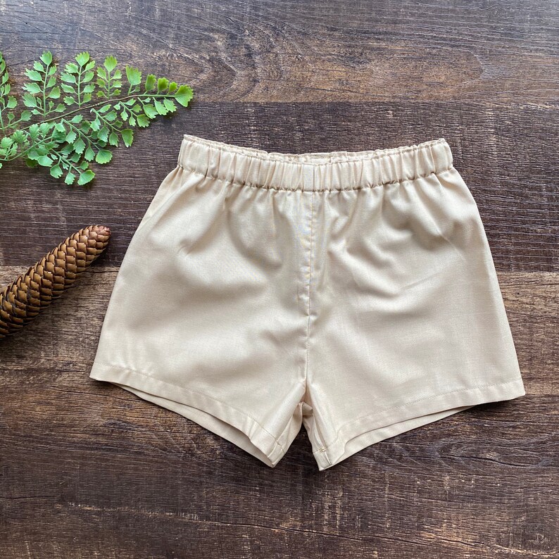 May include: A pair of beige shorts with an elastic waistband.