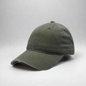 May include: Olive green baseball cap with a curved brim. The cap has a six-panel design with a button on top and an adjustable strap at the back. The fabric appears to be a soft cotton or similar material.