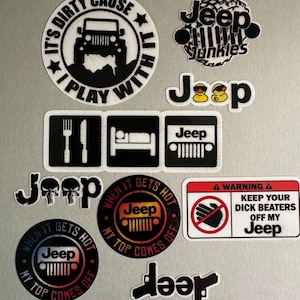 May include: A collection of Jeep-themed stickers in various shapes and designs. The stickers feature text like "It's Dirty Cause I Play With It," "Jeep Junkies," and "When It Gets Hot My Top Comes Off." Colors include black, white, red, and yellow.