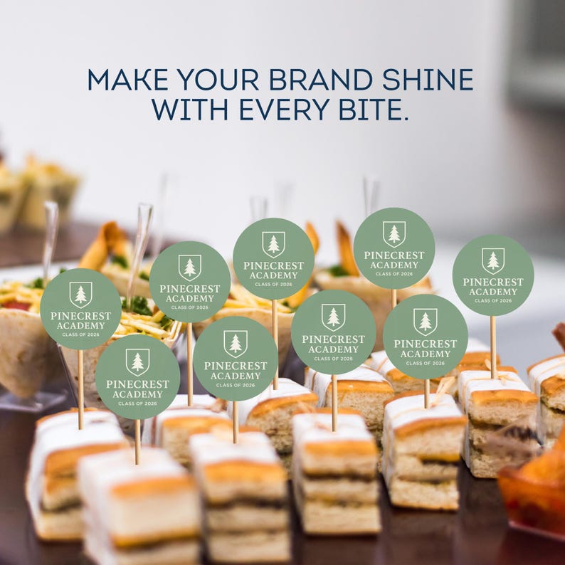 May include: An assortment of appetizers with small, round, light green Pinecrest Academy logo toppers on wooden skewers. The text "MAKE YOUR BRAND SHINE WITH EVERY BITE" is at the top of the image.