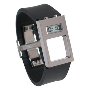 May include: A silver digital watch with a black rubber band. The watch face is rectangular and has a cutout in the center. The watch face displays the time as 11:11. The watch brand is ACME.