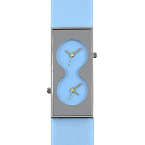 May include: A light blue wristwatch with a silver rectangular case and two round watch faces. The watch has a light blue leather band.