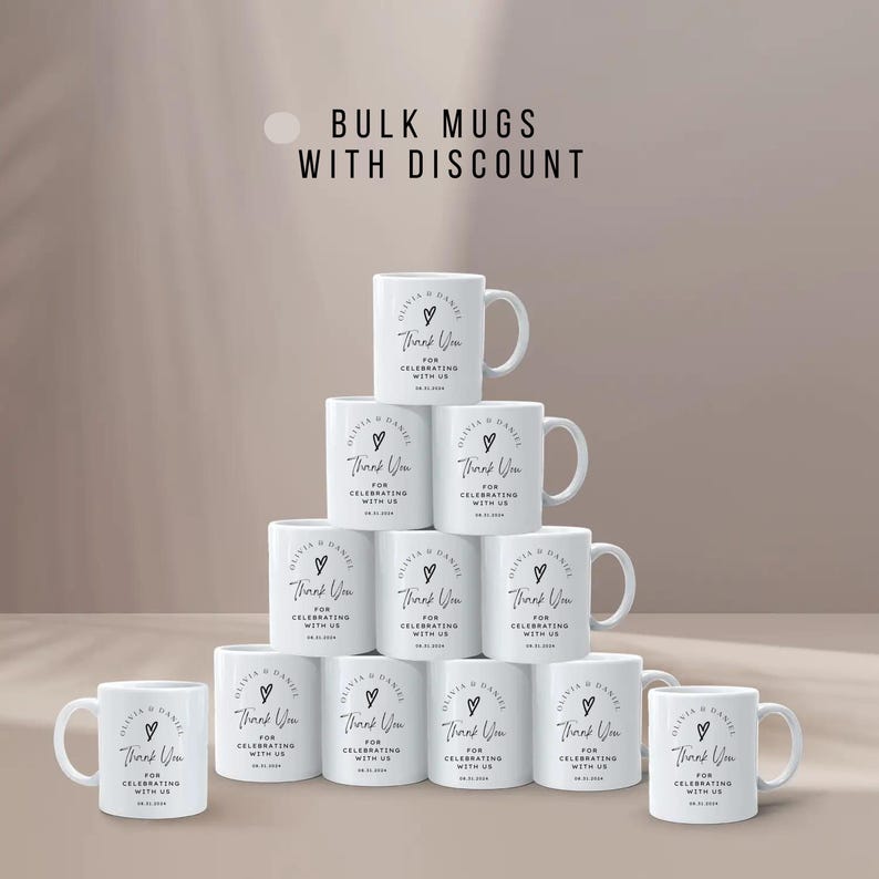 May include: A stack of 10 white ceramic mugs with black text that reads "Thank You for Celebrating with Us". The mugs are arranged in a pyramid shape. The text is in a simple, modern font.