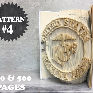 May include: A book art sculpture of the United States Marine Corps emblem. The sculpture is made from the pages of a book that has been folded and cut to create a three-dimensional design. The sculpture is on a shelf with the text "PATTERN #4 400 & 500 PAGES" visible.