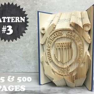 May include: A book art sculpture of the United States Coast Guard emblem. The sculpture is made from a book with 405 or 500 pages. The book is folded and shaped to create a 3D image of the emblem. The emblem is a circle with a shield in the center. The shield has a blue background with a white stripe down the center. The circle is surrounded by a rope and a life preserver. The text "PATTERN #3" is in a black starburst shape in the upper left corner of the image. The text "405 & 500 PAGES" is in white text in the lower left corner of the image.