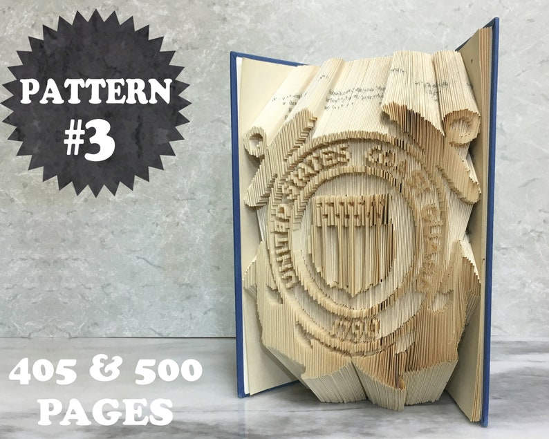 May include: A book art sculpture of the United States Coast Guard emblem. The sculpture is made from a book with 405 or 500 pages. The book is folded and shaped to create a 3D image of the emblem. The emblem is a circle with a shield in the center. The shield has a blue background with a white stripe down the center. The circle is surrounded by a rope and a life preserver. The text "PATTERN #3" is in a black starburst shape in the upper left corner of the image. The text "405 & 500 PAGES" is in white text in the lower left corner of the image.