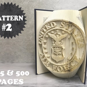 May include: A book with a 3D pop-up design of the United States Air Force emblem. The book is open to reveal the pop-up design, which is made of folded paper. The book is titled "PATTERN #2 325 & 500 PAGES".