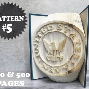 May include: A book with a 3D pop-up design of the United States Navy seal. The book is open and the seal is standing up. The book is made of white paper and has a blue cover. The text "PATTERN #5" and "350 & 500 PAGES" is visible on the image.