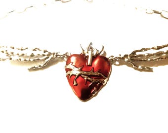 Red heart and hand with cross necklace