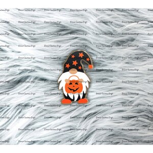 May include: A Halloween gnome with a black hat and a pumpkin face. The gnome is wearing a black and orange outfit and is holding a small pumpkin.