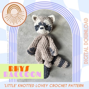 May include: A crocheted raccoon toy in shades of gray and beige, with a striped tail and dark gray accents. The text "Rhys Raccoon" and "Little Knotted Lovey Crochet Pattern" are visible. The image also includes the text "Digital Download".