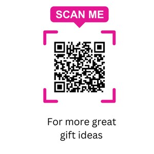 May include: A black and white QR code centered within a bright pink square frame. Above the frame is a pink speech bubble containing the white text SCAN ME. Below the frame, the black text reads For more great gift ideas in two lines.