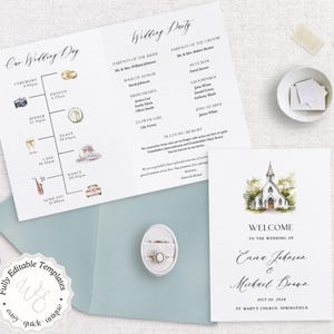 May include: A wedding invitation suite featuring a welcome card with a watercolor church illustration, a wedding party program, and a timeline of events. The suite includes a light blue envelope and a ring box. The text includes the names of the couple and the wedding date.