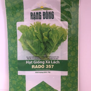 May include: A green and white packet of lettuce seeds with the text "RẠNG ĐÔNG" and "Hạt Giống Xà Lách RADO 357" on the front. The packet also includes the text "Theo TCCS 32:2014/RDHCM" and "Khối lượng tịnh: 10g".