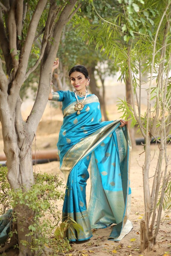 kanchipuram lichi silk saree gleams with gold zari floral buttas The sleek and elegant self zari floral brocade border beautifully