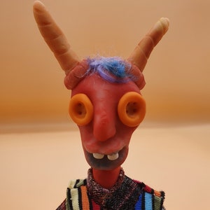 Devil boy is a handmade posable Artdoll has a unique personality sculpted from polymer clay with a wire armature. He is a collectable.