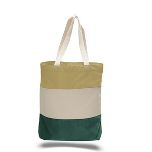 May include: A striped canvas tote bag with beige, white, and green stripes. The bag has two white cotton straps.