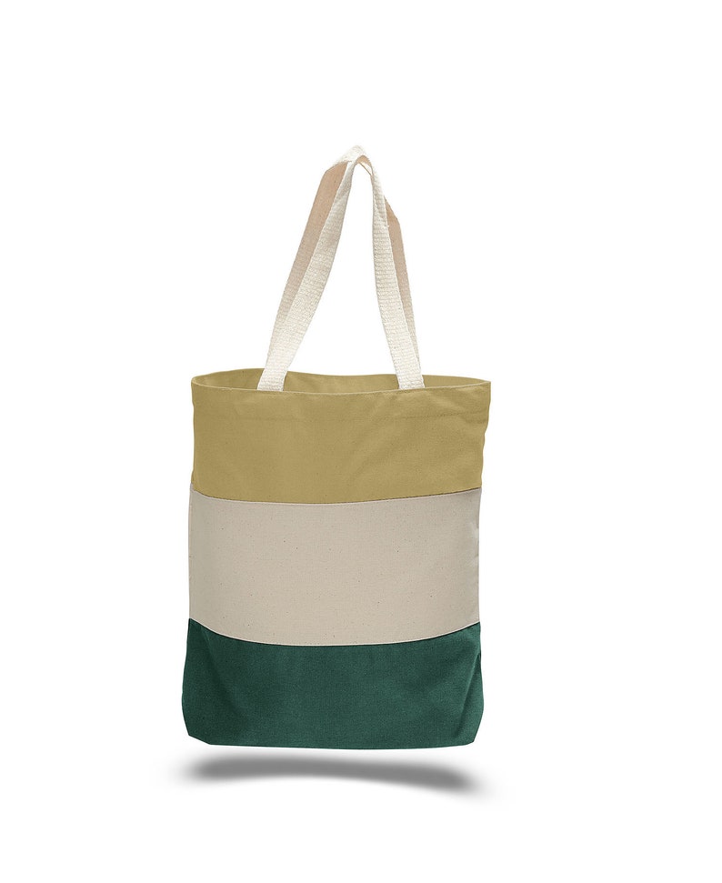 May include: A striped canvas tote bag with beige, white, and green stripes. The bag has two white cotton straps.