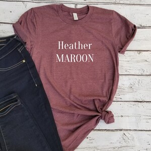 May include: A maroon t-shirt with the text "Heather MAROON" printed in white on the front.