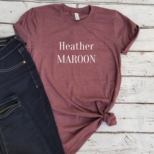 May include: A maroon t-shirt with the text "Heather MAROON" printed in white on the front.