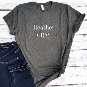 May include: A heather gray t-shirt with the text "Heather GRAY" printed in white on the front.