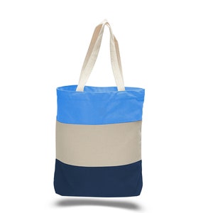 May include: A blue, beige, and navy blue striped tote bag with cream-colored handles.