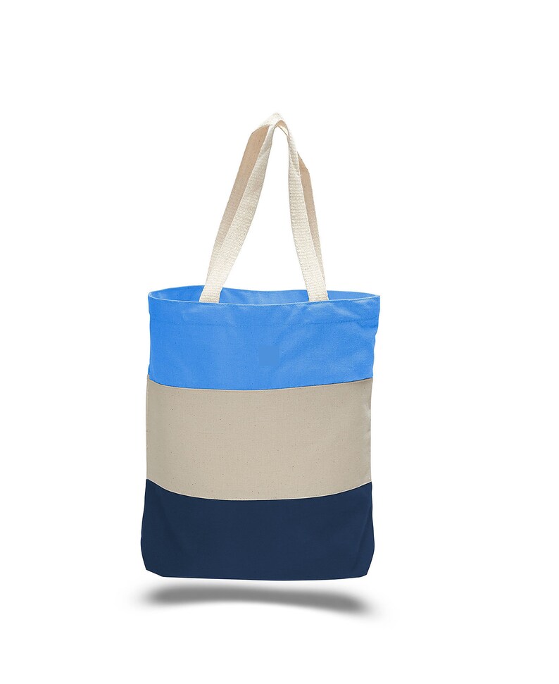 May include: A blue, beige, and navy blue striped tote bag with cream-colored handles.