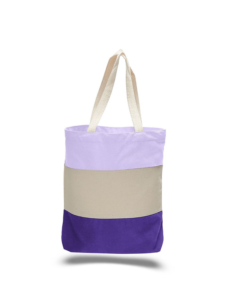 May include: A purple, beige, and lavender striped tote bag with cream-colored handles.