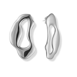 A pair of silver abstract earrings. The earrings are shaped like a wavy, organic form with a cutout in the center. The earrings are a modern and stylish design.