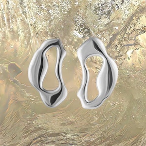 Bold sterling silver statement earrings with fluid organic shape — modern handmade jewelry inspired by ocean forms.