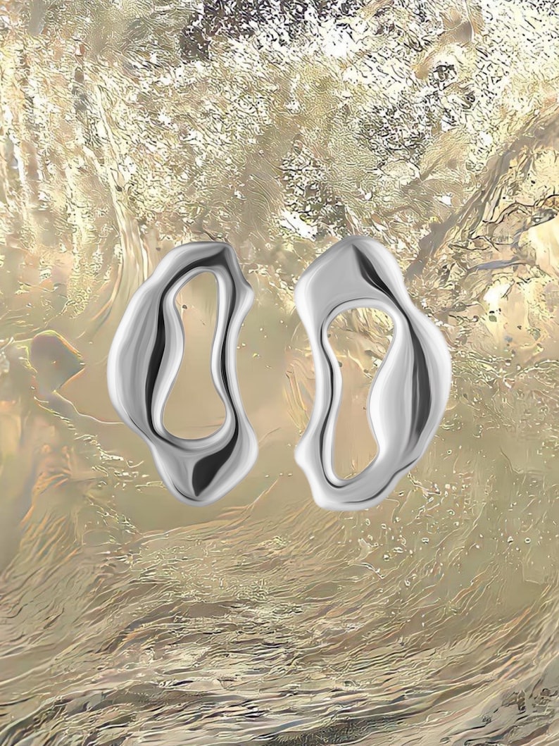 Bold sterling silver statement earrings with fluid organic shape — modern handmade jewelry inspired by ocean forms.