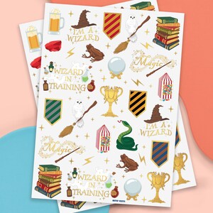 May include: Two sheets of stickers with a wizard theme. The stickers feature a wizard hat, owl, broom, books, potion bottles, and the text "I'm a + Wizard" and "Wizard in Training". The stickers are in various colors, including gold, green, and brown.