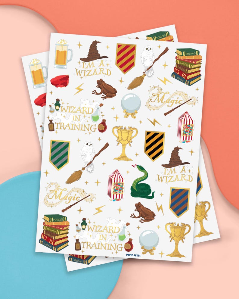 May include: Two sheets of stickers with a wizard theme. The stickers feature a wizard hat, owl, broom, books, potion bottles, and the text "I'm a + Wizard" and "Wizard in Training". The stickers are in various colors, including gold, green, and brown.