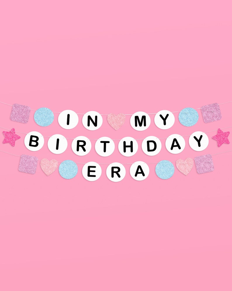 May include: A pink and blue birthday banner with the words "It's My Birthday Era" in white letters on a white background.