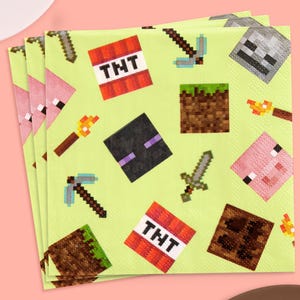 May include: A stack of light green paper napkins with pixelated graphics. The napkins feature images of a pig, TNT blocks, swords, pickaxes, torches, and other game-related icons. The napkins are designed with a video game theme.