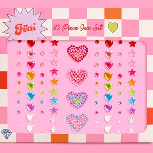 May include: A pink box set of 82 gem stickers. The set includes heart, star, and round-shaped gems in various colors, including red, pink, yellow, green, blue, and purple. The box has the word "Jetti" and "82 Piece Gem Set" printed on it.