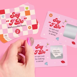 May include: Pink and white cards with a retro design featuring the text "Say "I Do"" and "Bachelorette Dares". The cards have a silver scratch-off area and include phrases like "or opt out by taking a drink!" and "Slide into a celebrity's DMs."