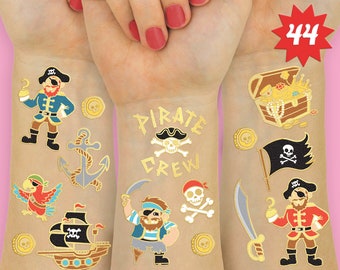 May include: Gold pirate themed temporary tattoos with images of a pirate ship, a parrot, an anchor, a pirate with an eyepatch, a pirate with a beard, a treasure chest, a skull and crossbones, and gold coins. The text "Pirate Crew" is also included.
