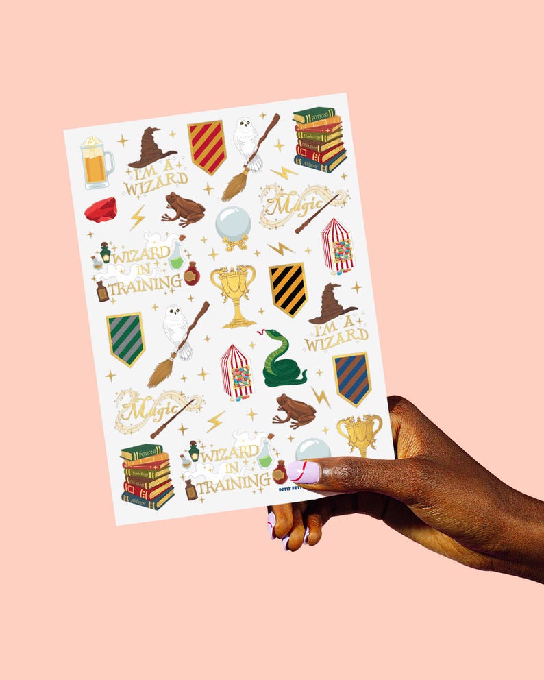 May include: A sheet of stickers featuring various wizard-themed illustrations. The stickers include a wizard hat, a golden trophy, a green snake, a frog, a broom, and the text "I'M A+ WIZARD" and "WIZARD IN TRAINING".