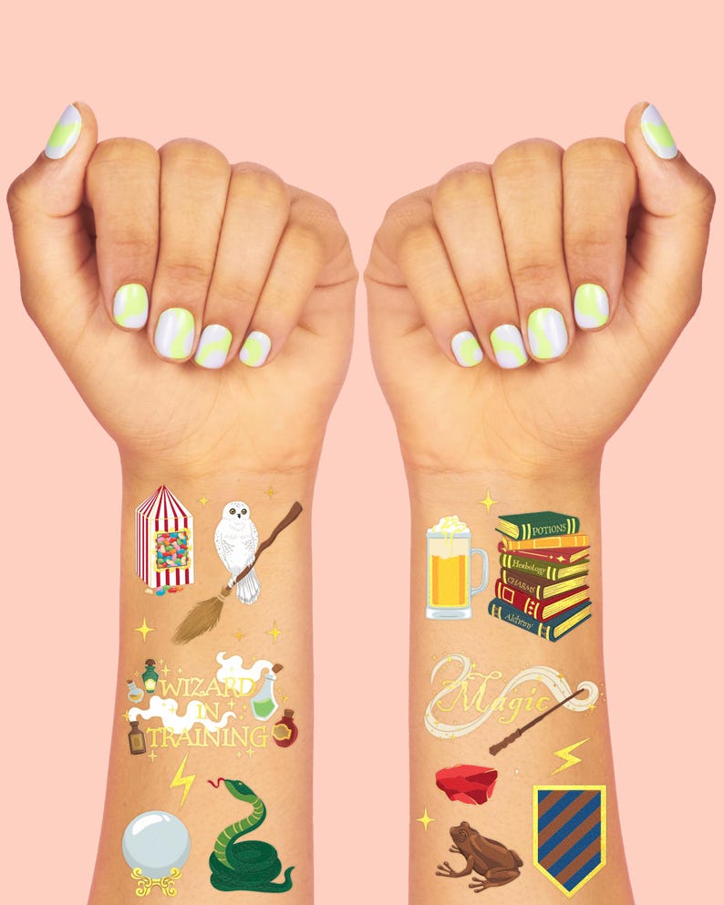 May include: Temporary tattoos featuring wizarding-themed designs. The designs include a candy cart, an owl on a broom, potion bottles, a snake, a crystal ball, a stack of books, a beer mug, a magic wand, a frog, and a shield. The background is a light pink.