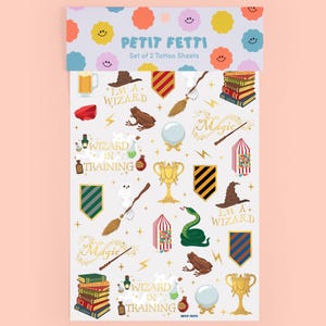 May include: Set of two tattoo sheets featuring wizard-themed illustrations. Designs include a wizard hat, broom, books, a frog, a snake, and the text "I'M A+ WIZARD" and "WIZARD IN TRAINING". The top of the sheet has colorful smiley face designs.